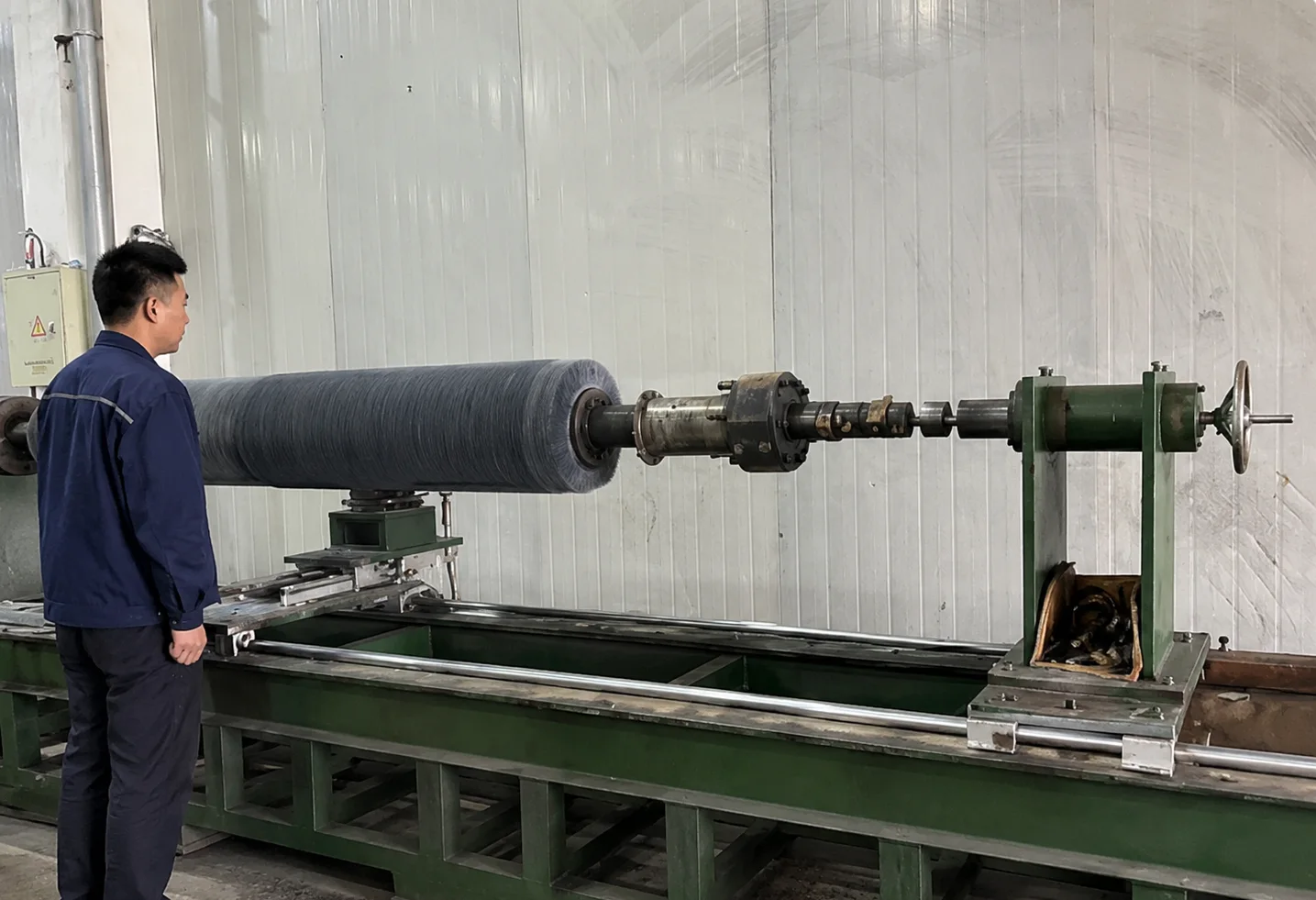 Large industrial roller brush undergoing outside diameter trimming and finishing