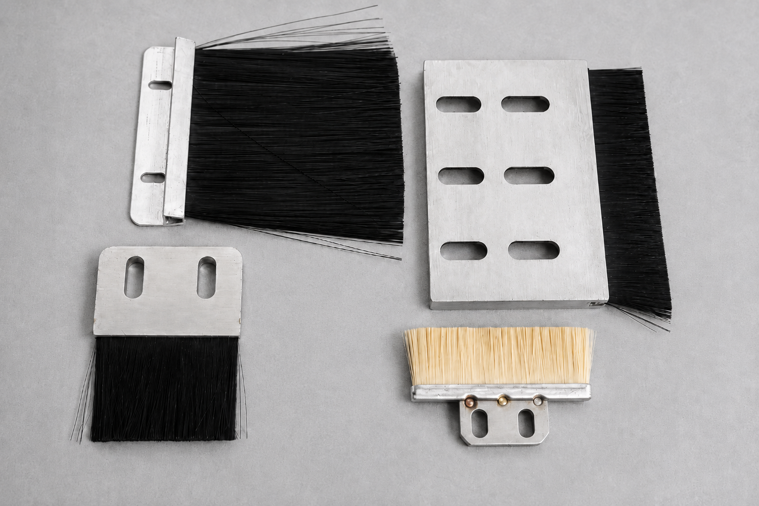 Flat lubrication brushes with metal backings and mounting slots