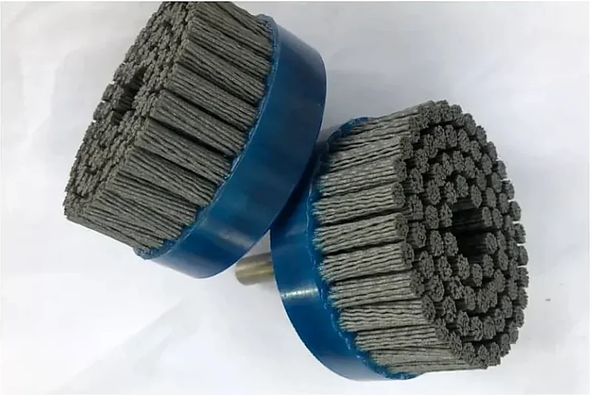 Abrasive nylon disc brush with molded hub on a clean white background