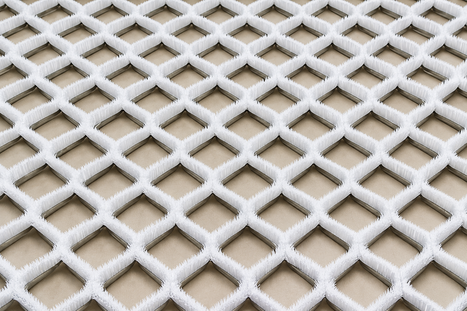 Diamond-lattice dry ski slope bristle mat made from formed metal channel strip brushes