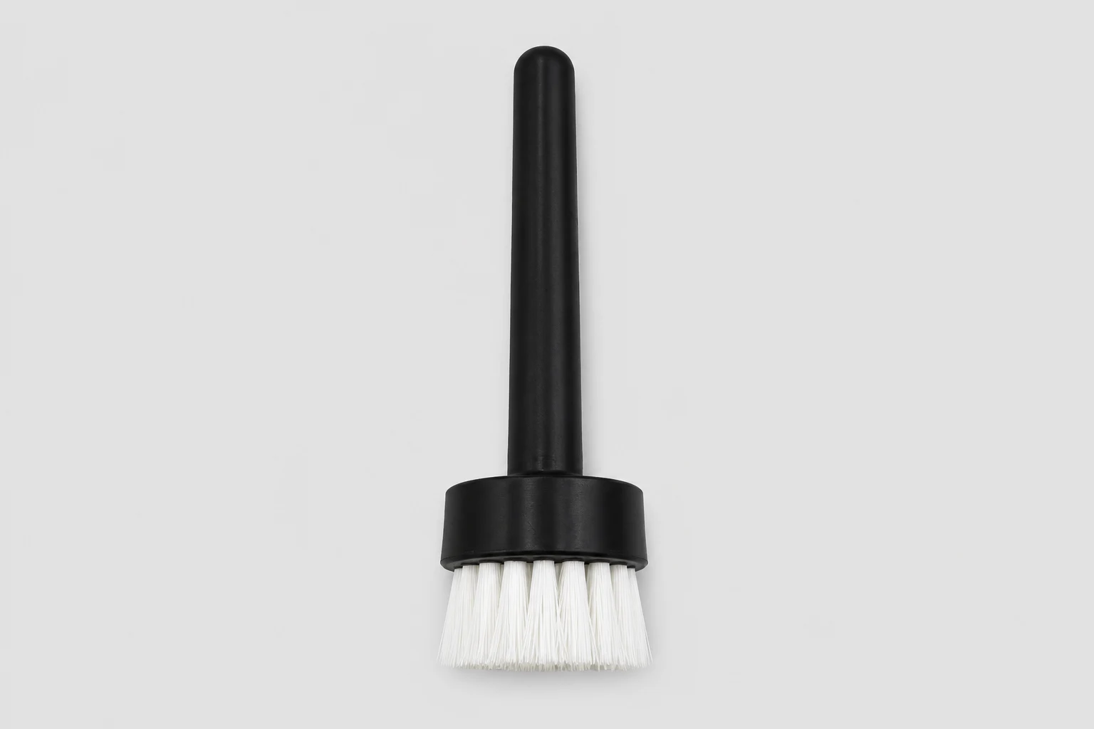 Tufted end brush with plastic body and axial working face