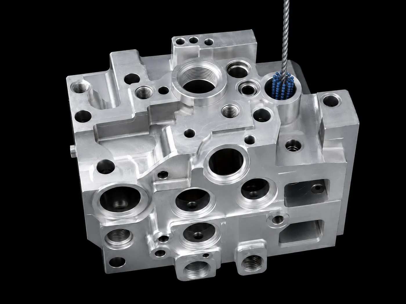 Aerospace hydraulic manifold with internal brush for bore and passage finishing
