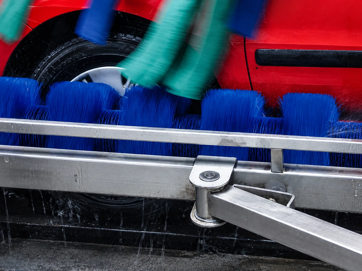 Segmented roller brush assembly for lower body car washing