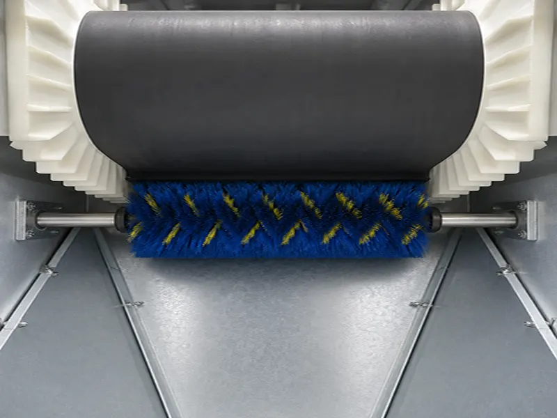 Vertical rotary brush cleaning module beside conveyor equipment