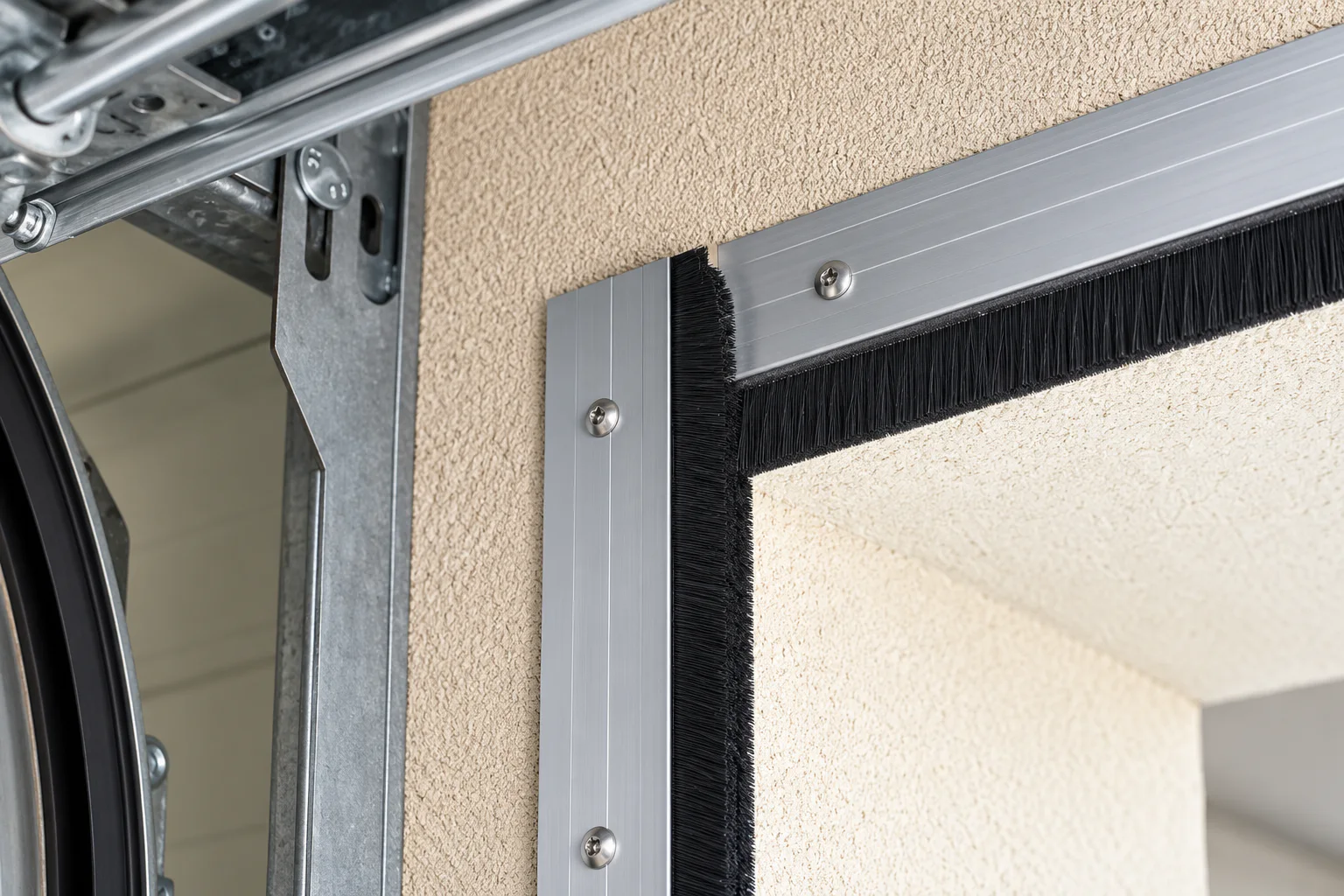 Top and side brush seal installed around a sectional overhead door opening