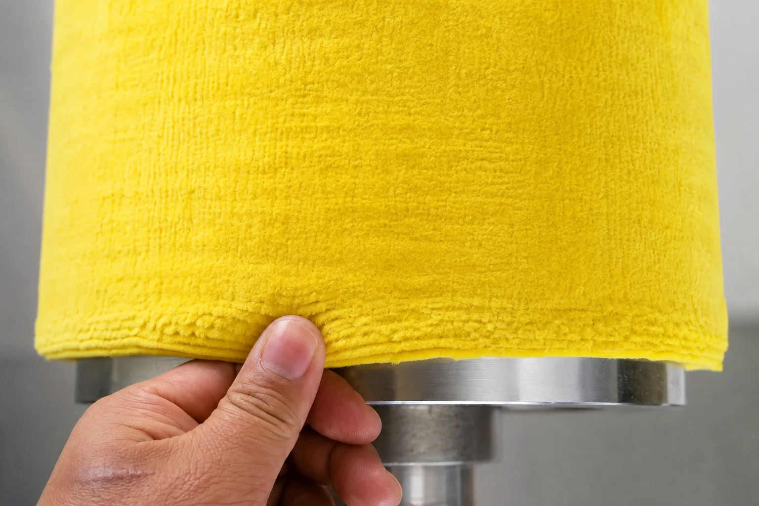 Close-up of non-woven mill roll surface for liquid control and oiling