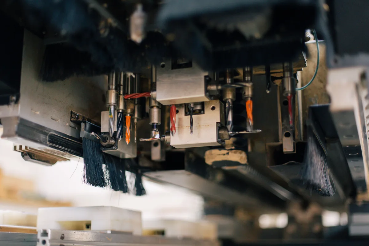 Strip brush dust skirts surrounding a machine drilling head