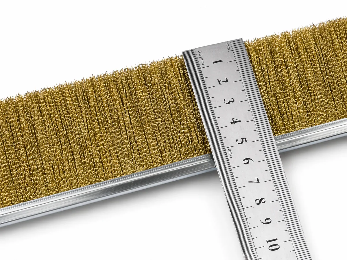 Conductive strip brush filament close-up with ruler for dimensional review