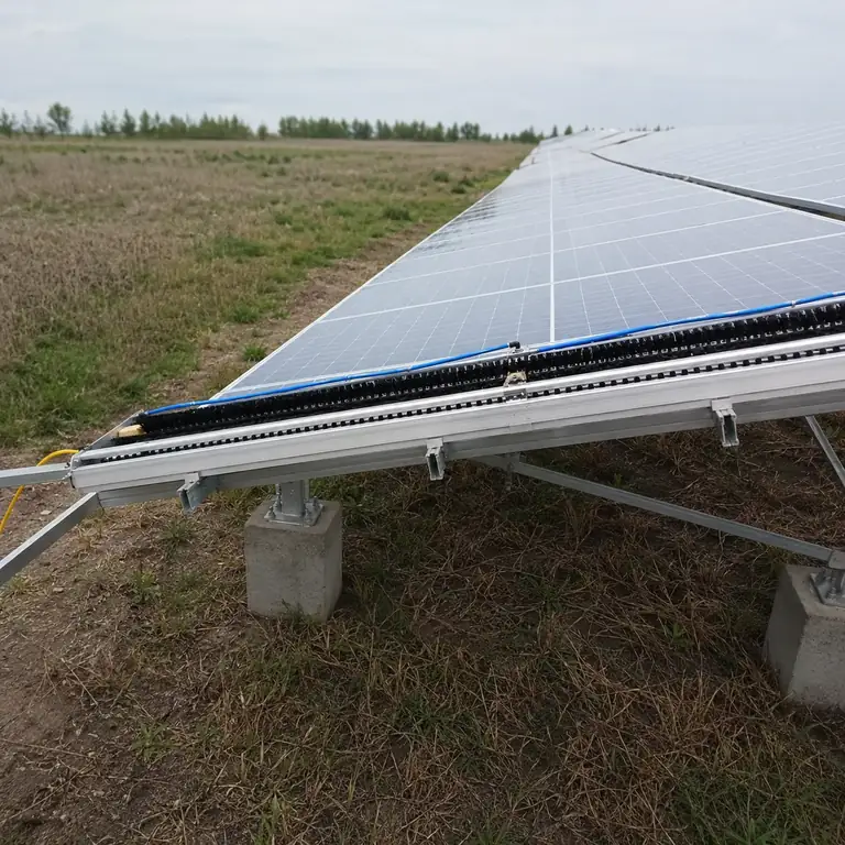 Installed solar cleaning brush system on a large panel row for fleet program supply