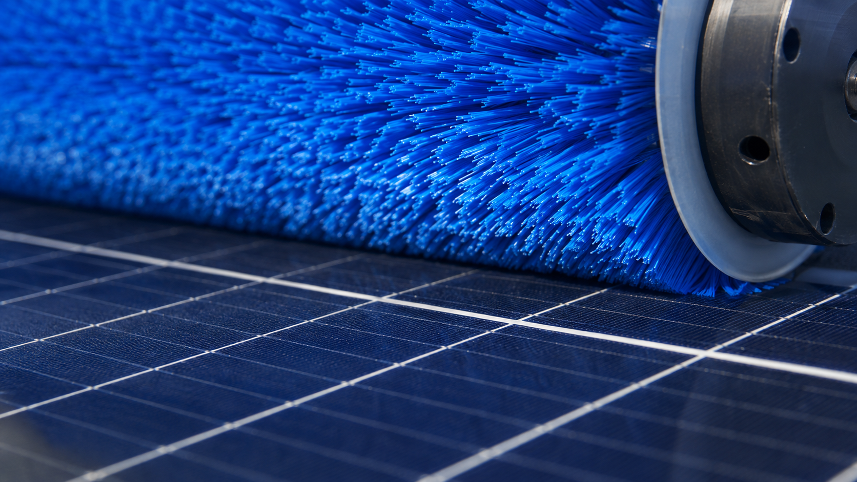 Cylinder brush cleaning solar panels in a solar energy system