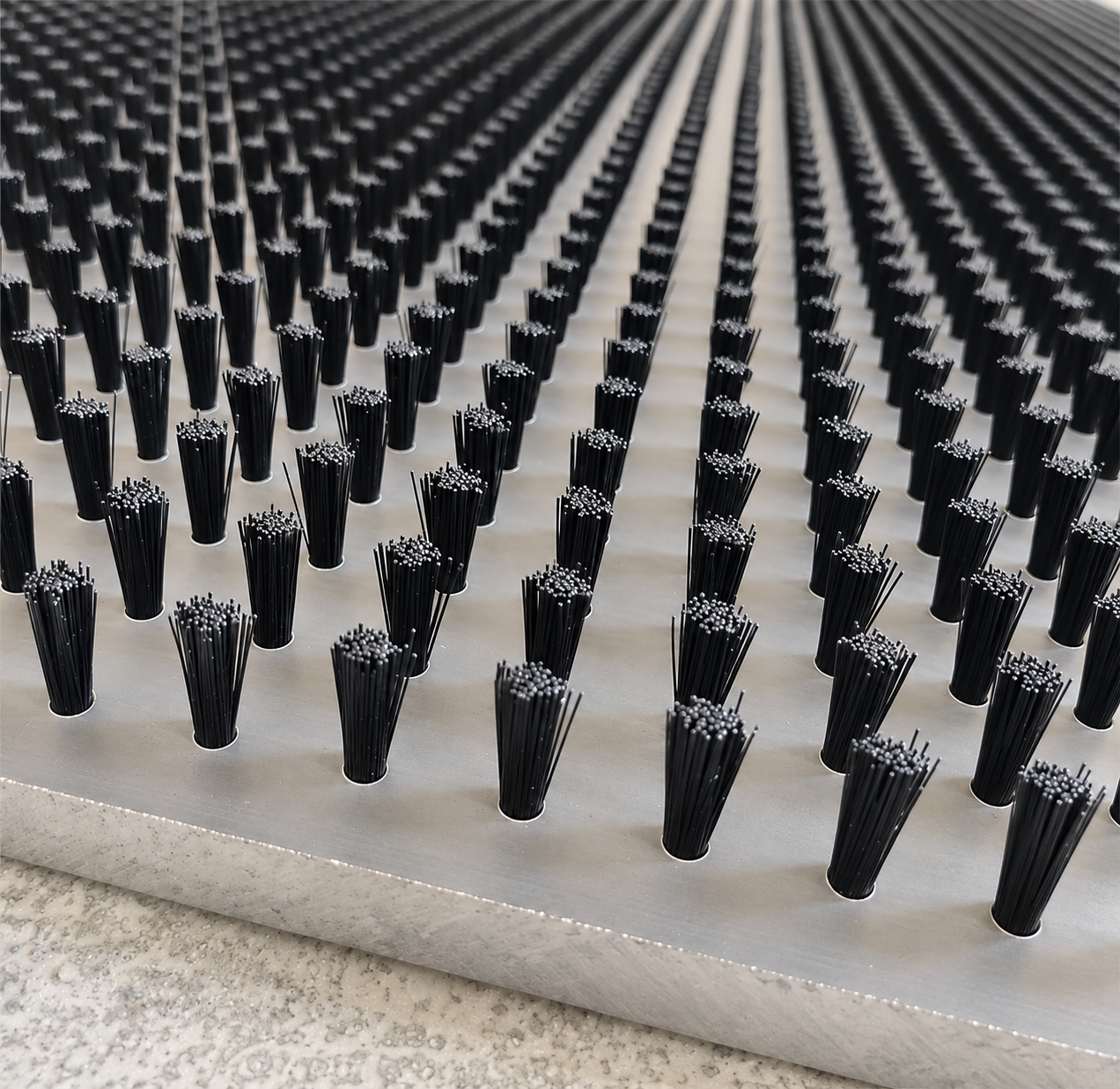 Flat plate table brush with a drilled aluminum base and tufted bristles