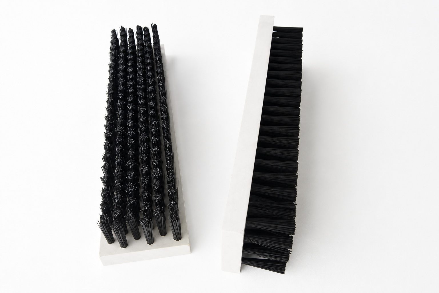 Straight lath brushes with narrow rigid bases and black tufted bristles