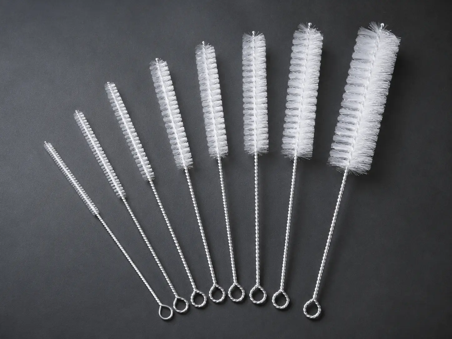 Synthetic pipe and tube brushes for wet or chemical environments