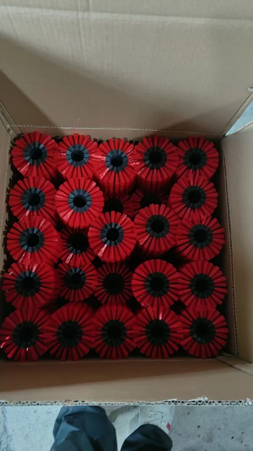 Red-bristled zig-zag brush segments packed upright in a cardboard carton