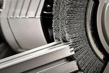 Disc brush deburring and blending machined metal edges