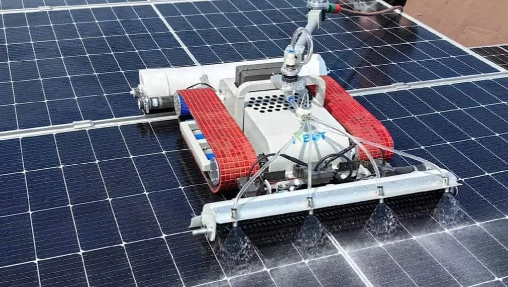 Rotating solar panel cleaning equipment with brush contact on rooftop photovoltaic panels