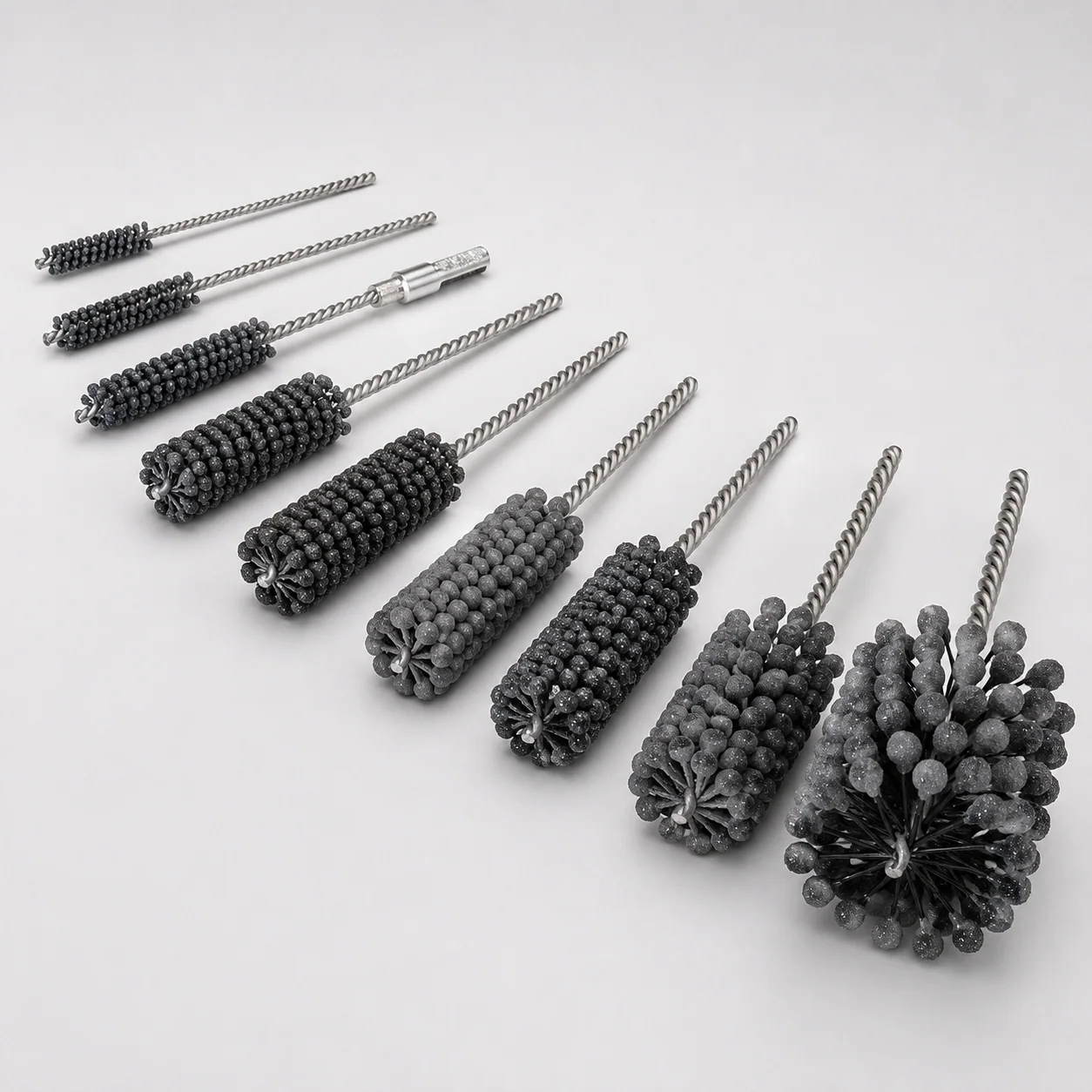 Ball-type honing brushes with silicon carbide abrasive globules for industrial bore finishing