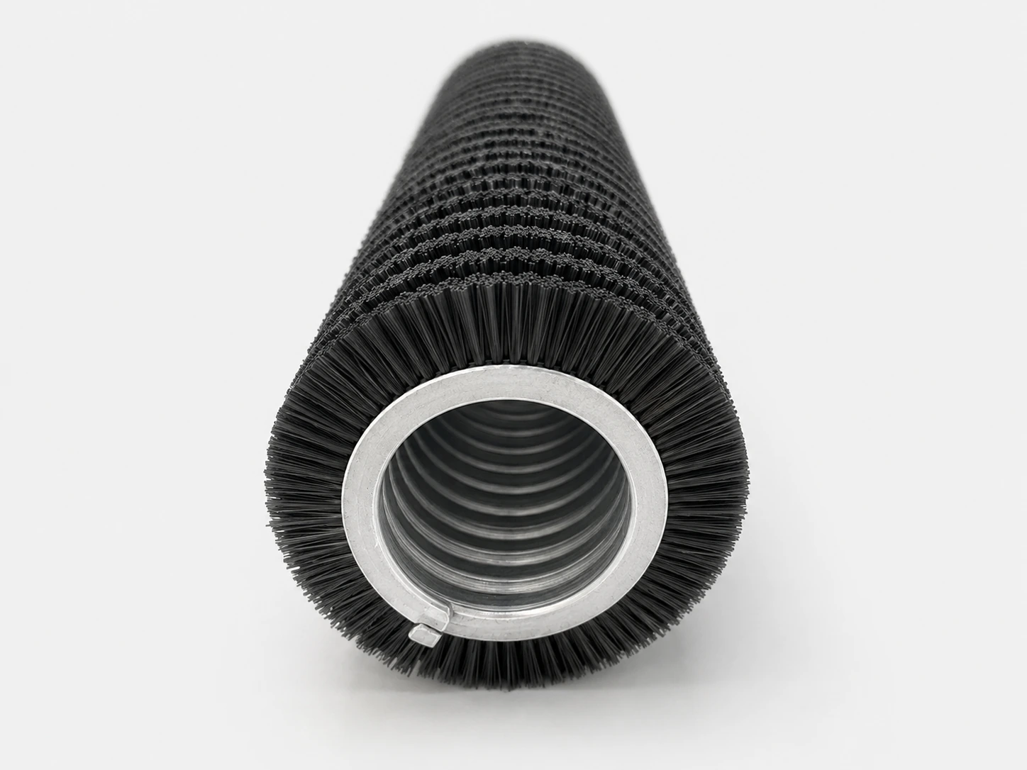 Close-wound spiral brush with dense continuous coverage on a cylindrical core
