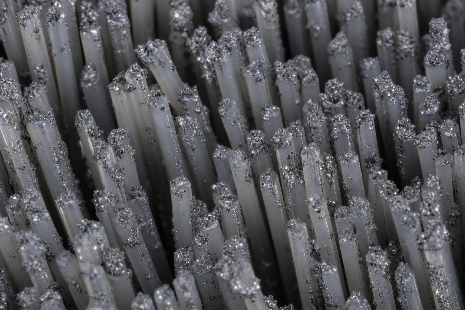 Abrasive nylon filament for controlled deburring and edge finishing