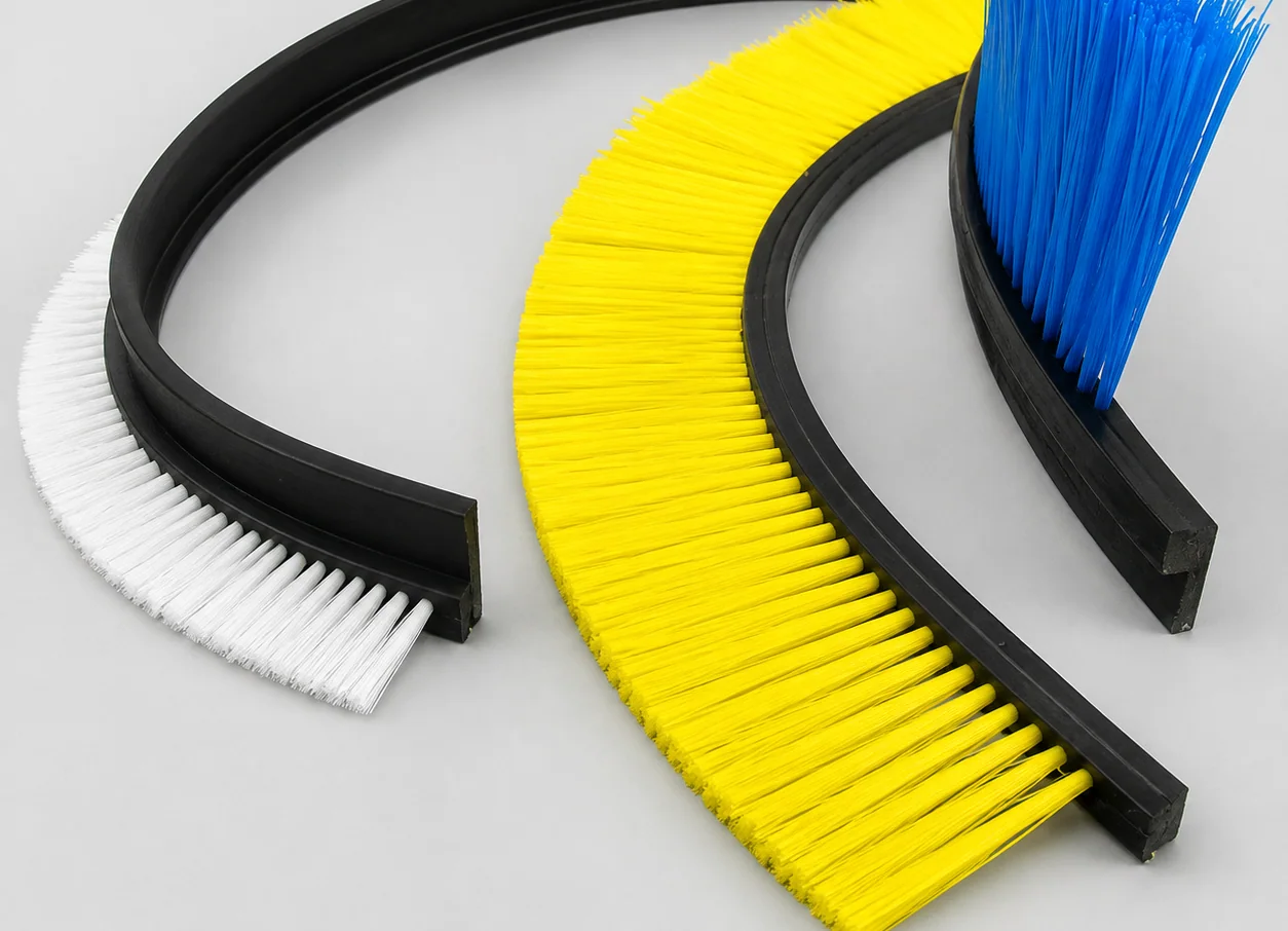 Tufted flexible-profile strip brush with filament bundles secured in a rubber profile