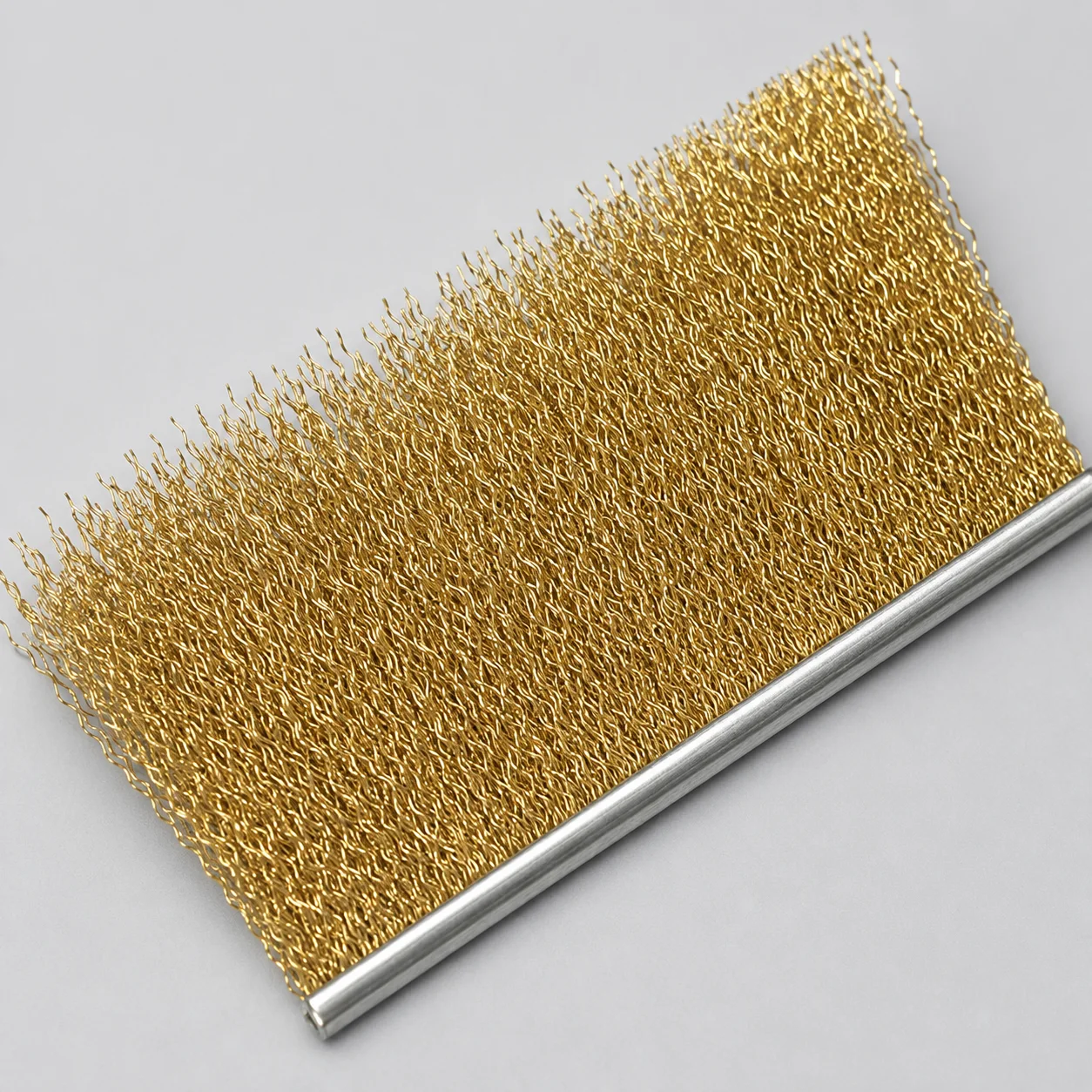 Brass wire filament for metal channel strip brushes