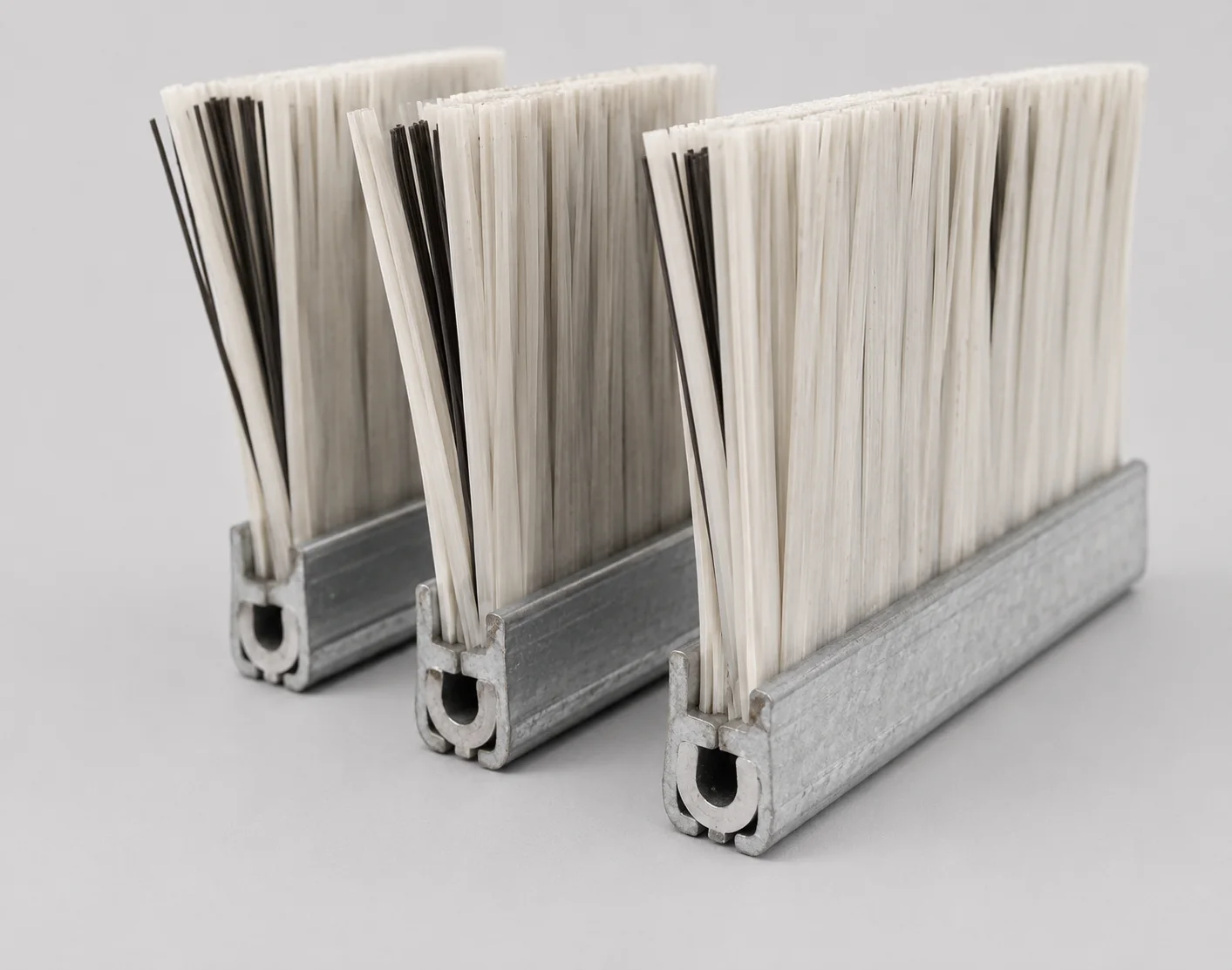 PP or nylon strip brush construction reinforced with flat steel wire inside the channel
