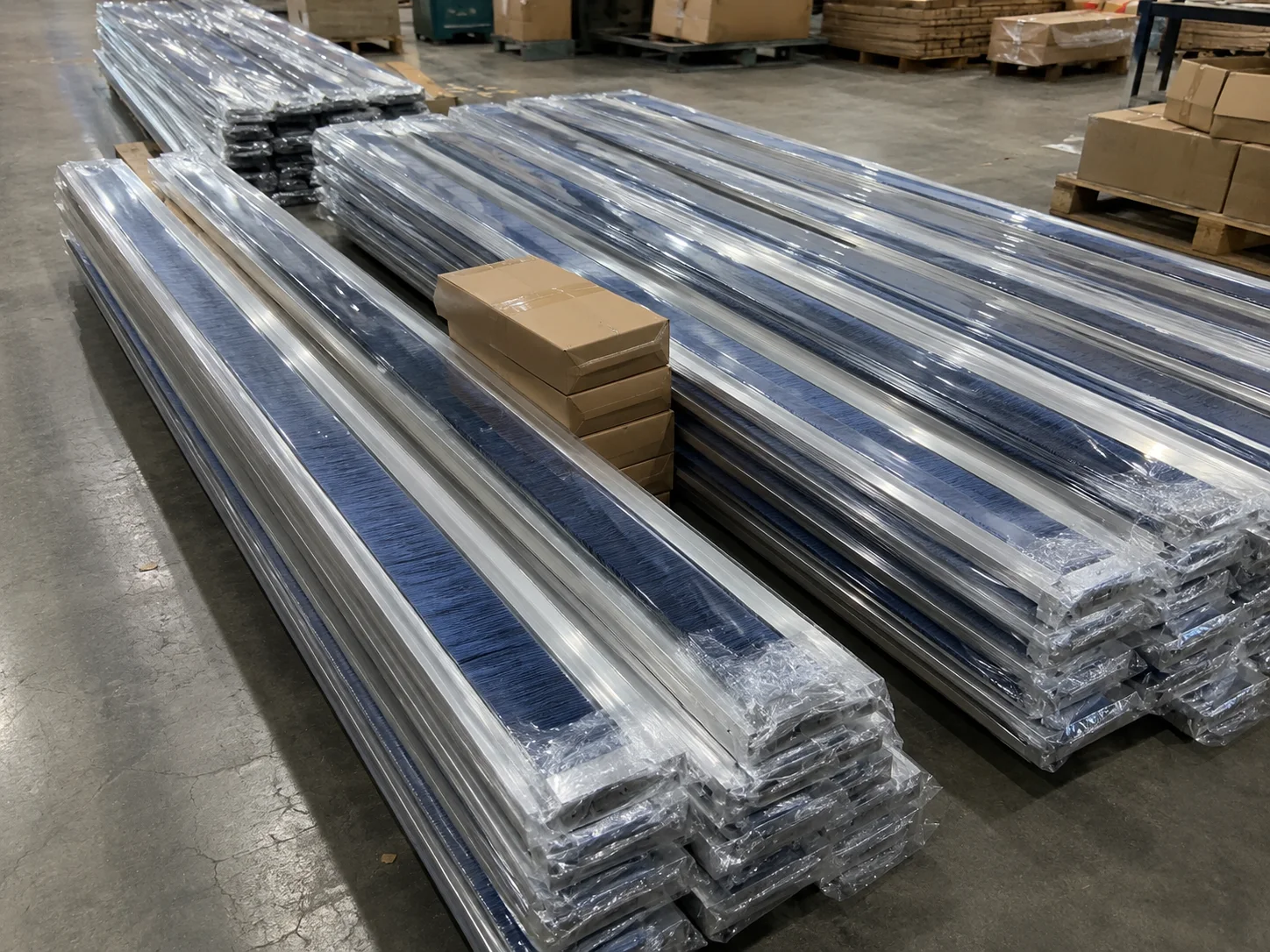 Long metal channel strip brushes individually wrapped and stacked for shipment
