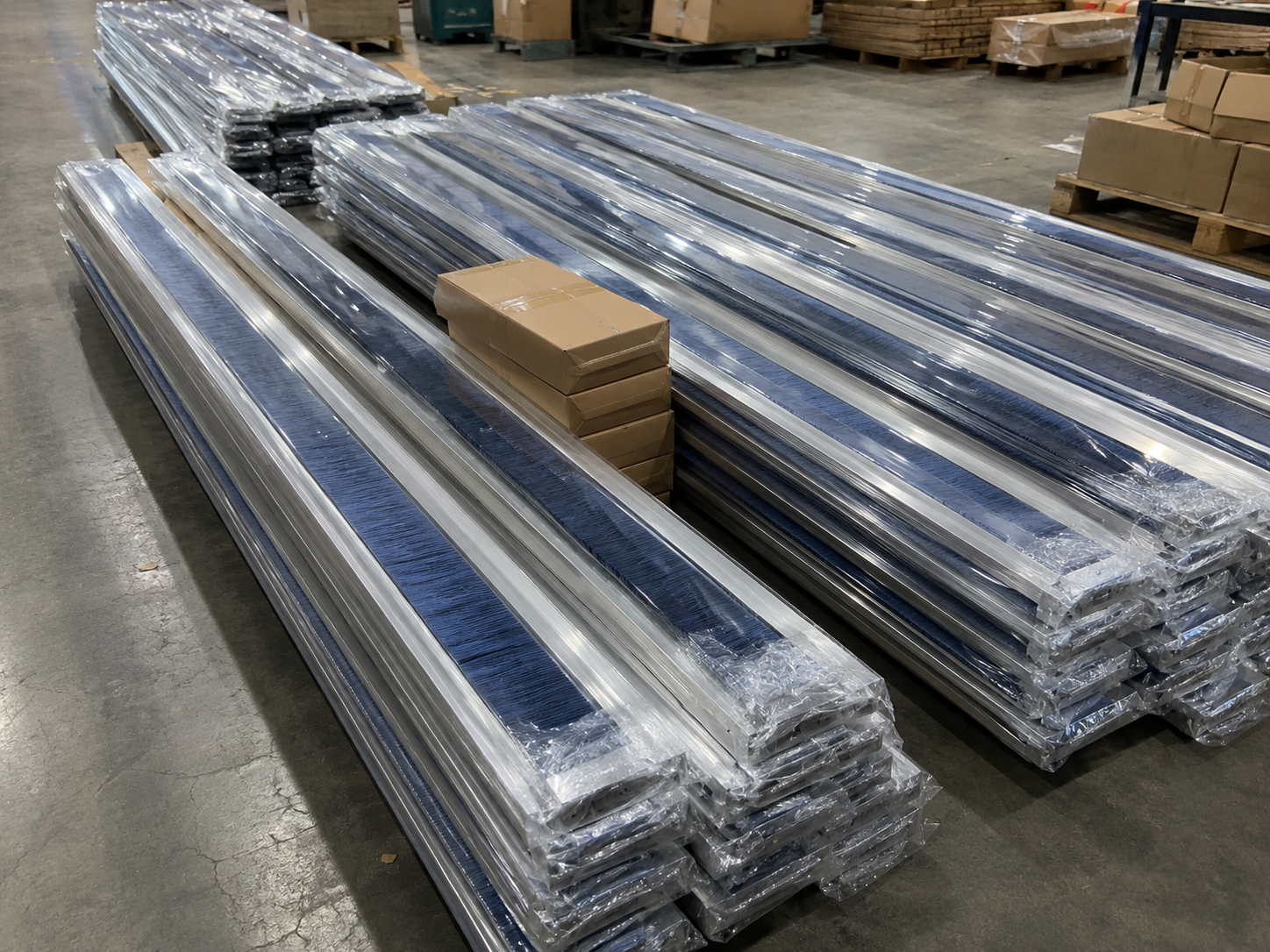 Long metal-channel strip brushes individually protected and stacked for batch packing
