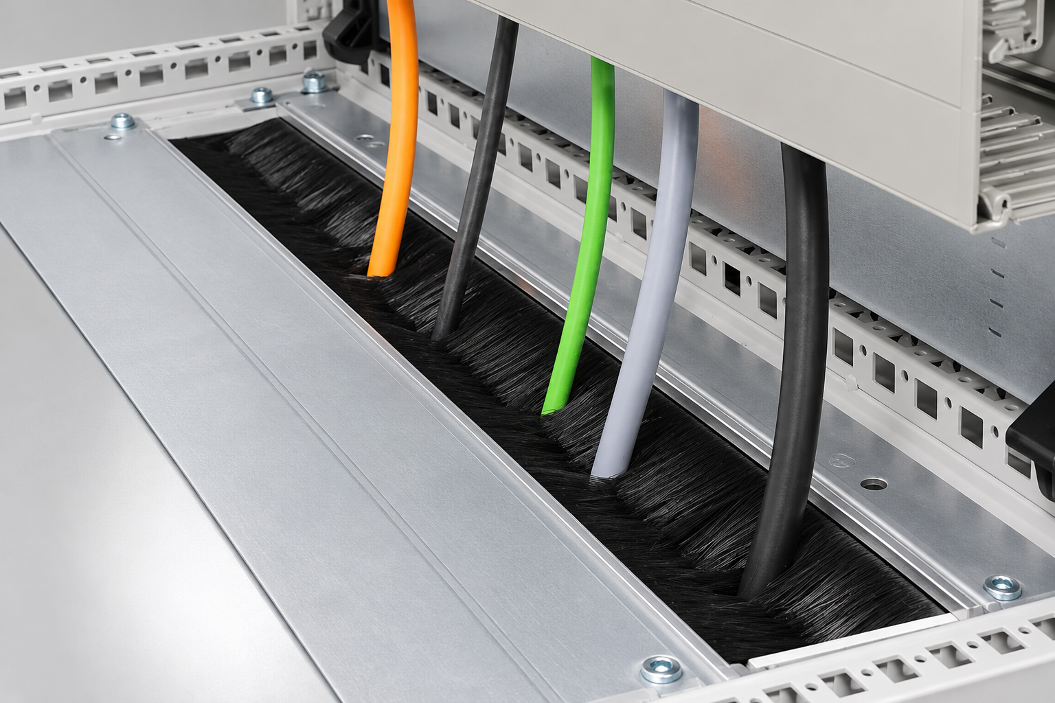 Strip brushes lining a cable-entry opening in a control cabinet base plate