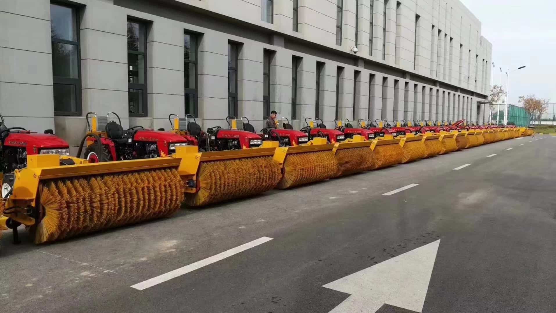 Road sweeper trucks with cylindrical main broom brushes ready for pavement cleaning